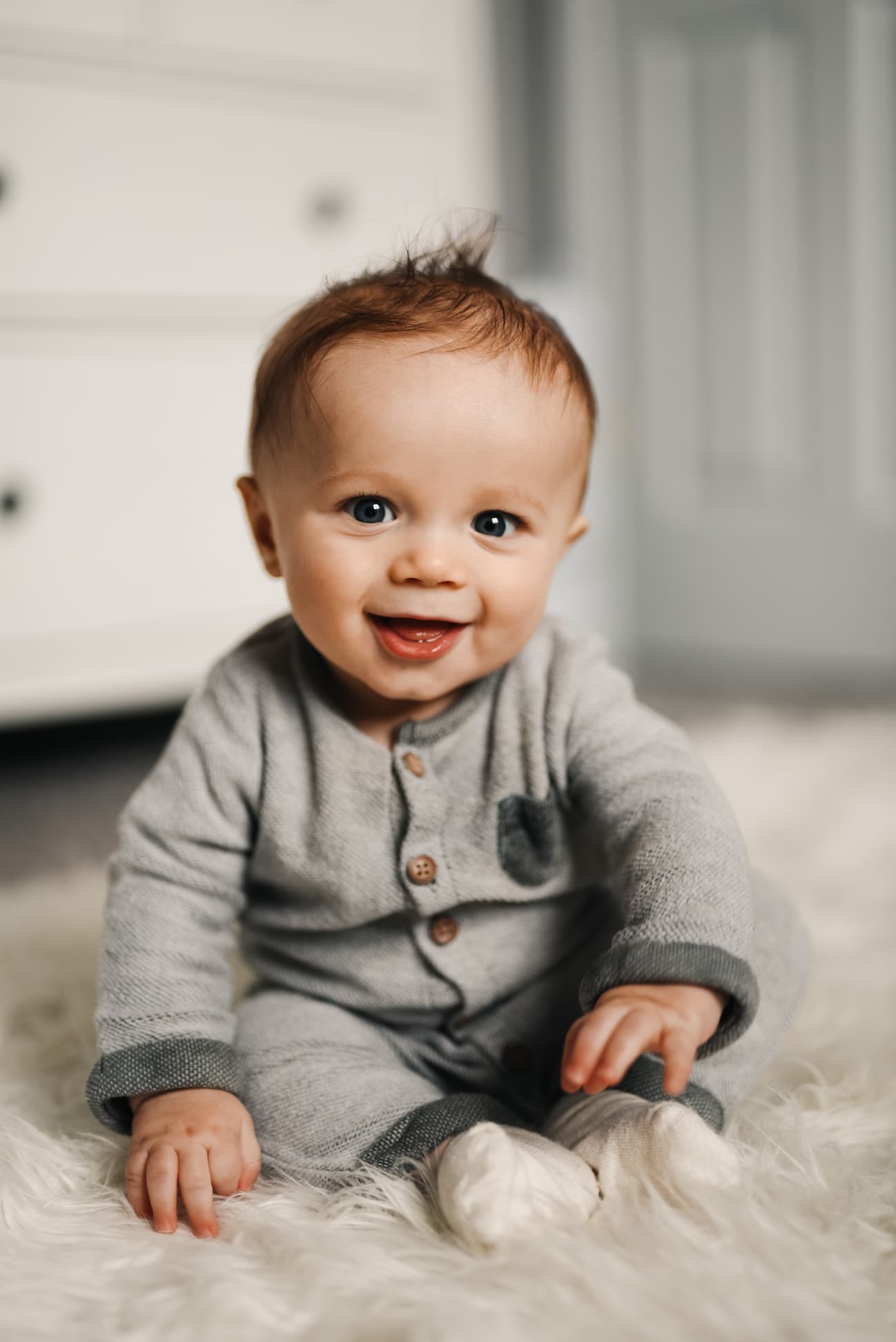 Baby sitting up smiling