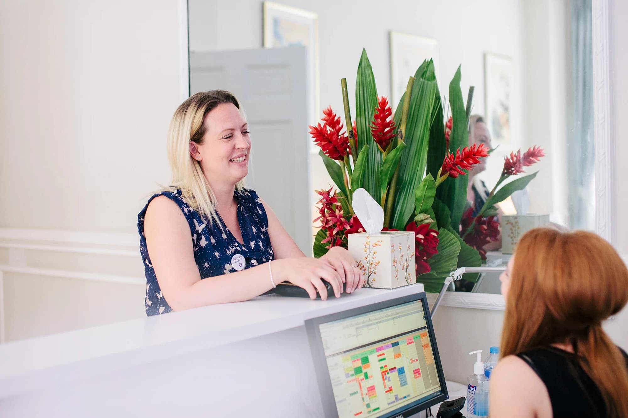 Blonde IVF patient standing at reception