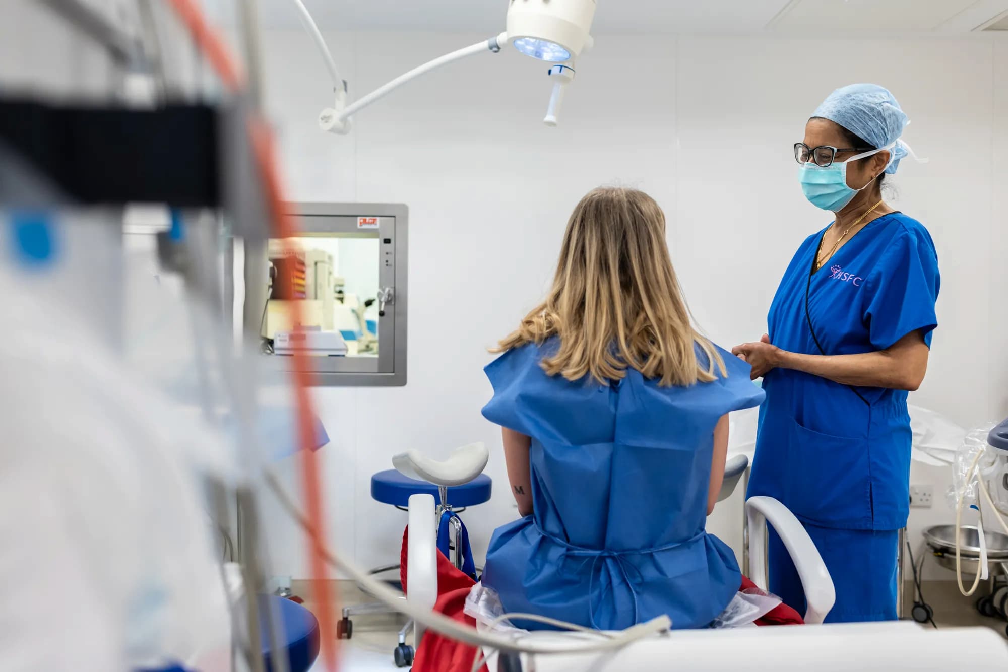 Dr Venkat, medical director at Harley Street, talking to an IVF patient in the theatre