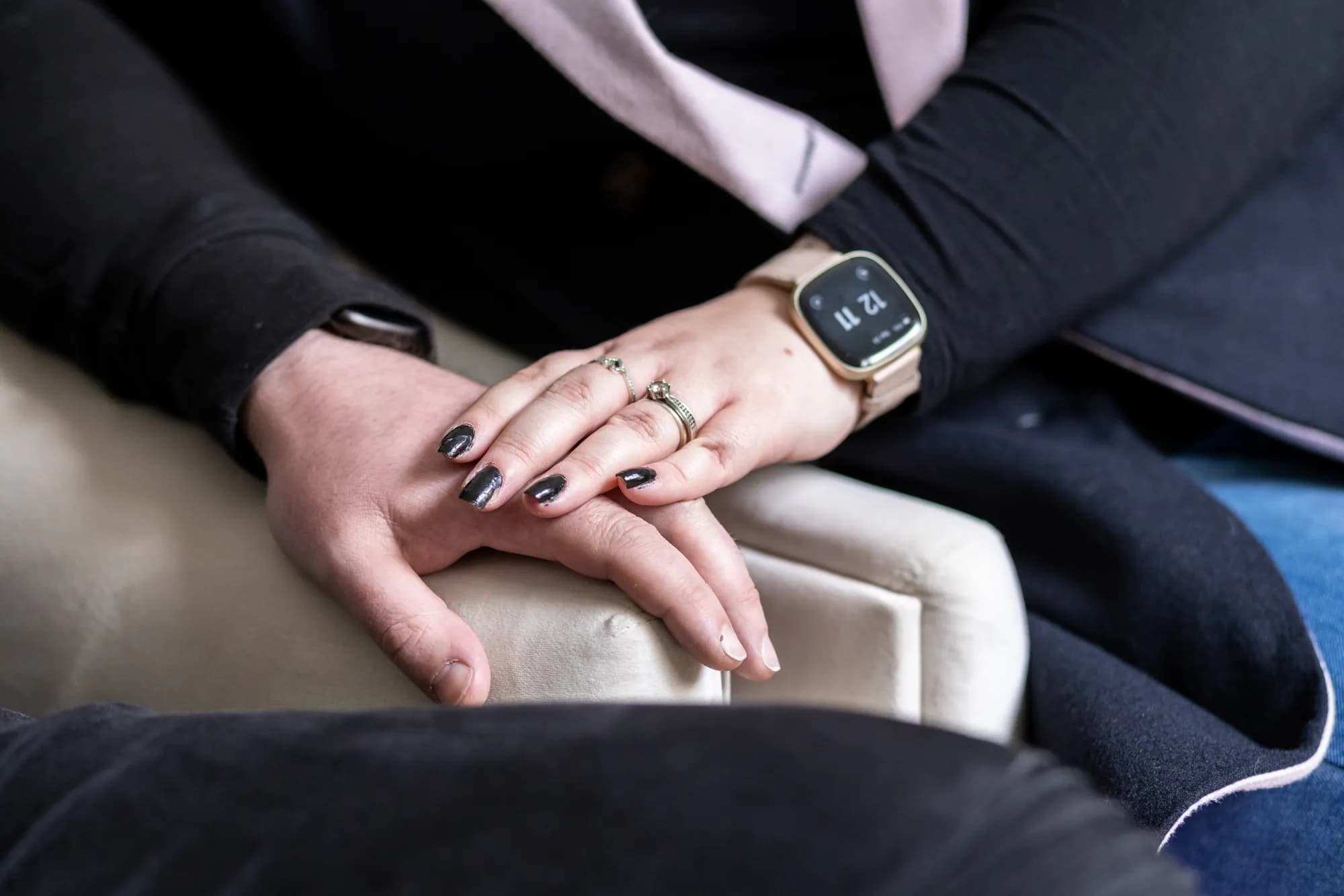 IVF patients finding comfort and connection. Intertwined male and female hands on armchair, symbolizing unity and shared IVF journey.