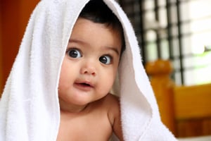Cute Indian baby with blanket over head