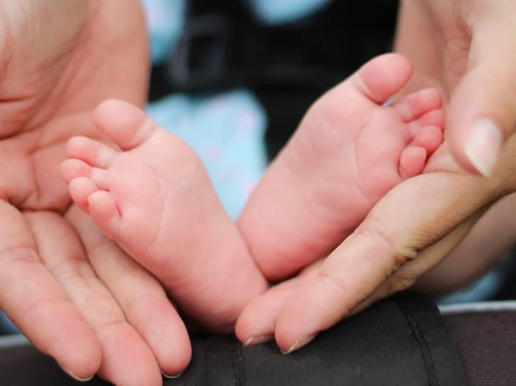 Baby feet in adult hand