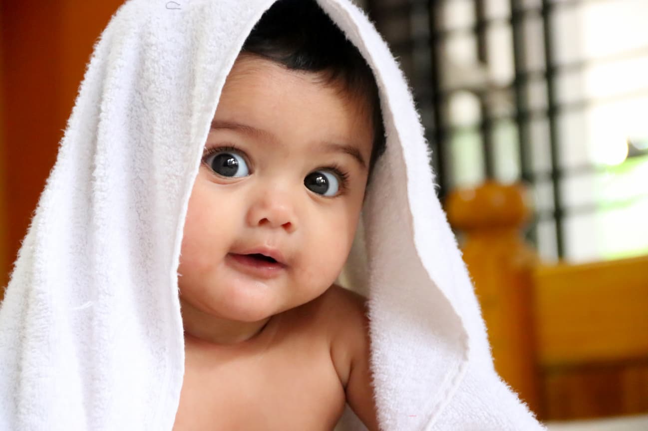 Cute Indian baby with blanket over head